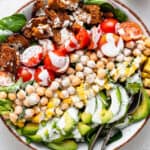 overhead of a bowl with layered vegan cobb salad and creamy dressing