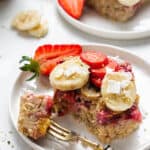 close up on a square of strawberry baked oats topped with fresh fruit