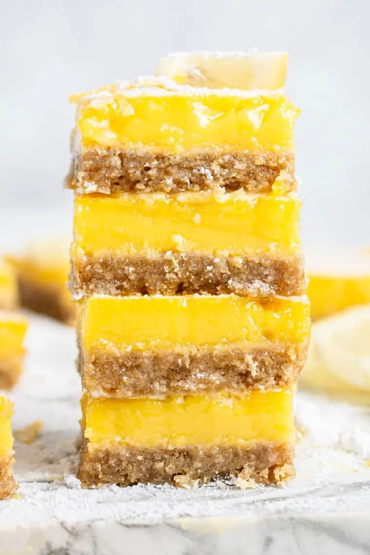 stack of four lemon bars with almond crust and lemon filling