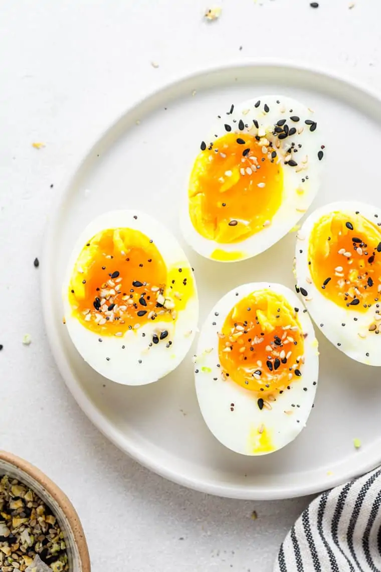 close up on a plate with jammy soft boiled eggs