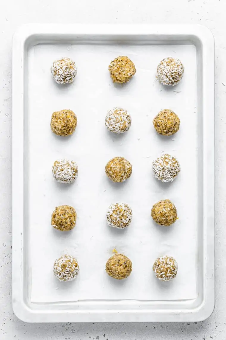 baking sheet with energy balls rolled in coconut