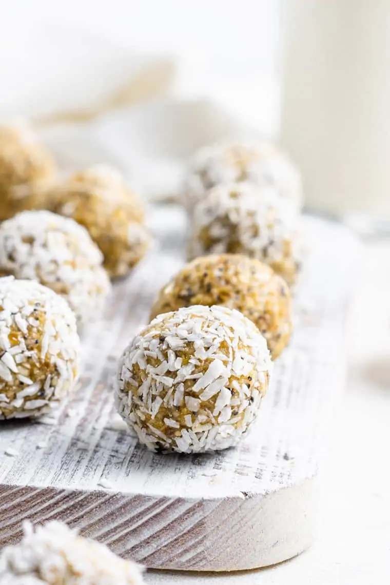 close up on a wooden board with lemon poppy seed energy bites