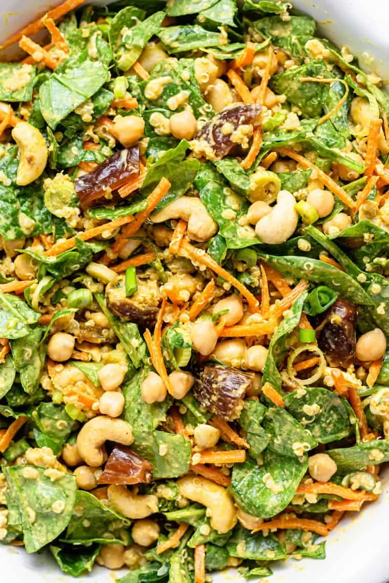 close up on details of chickpea quiona salad with spinach and dates