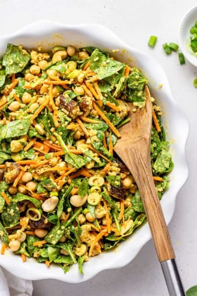 close up on spicy moroccan salad with dates and carrots in a white bowl