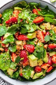 close up on strawberry salad with quinoa and spinach