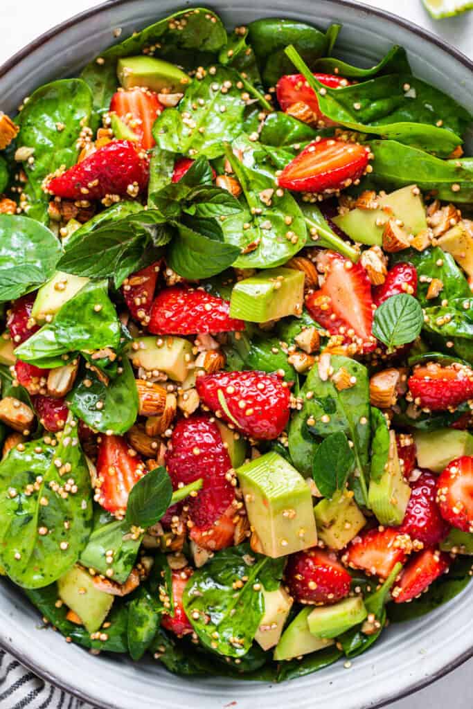 close up on strawberry salad with quinoa and spinach