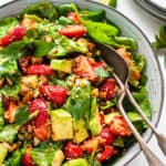 bowl of strawberry spinach avocado salad with dressing