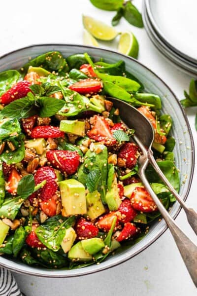 bowl of strawberry spinach avocado salad with dressing