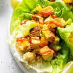 close up on lettuce wraps with mango, tofu and quinoa