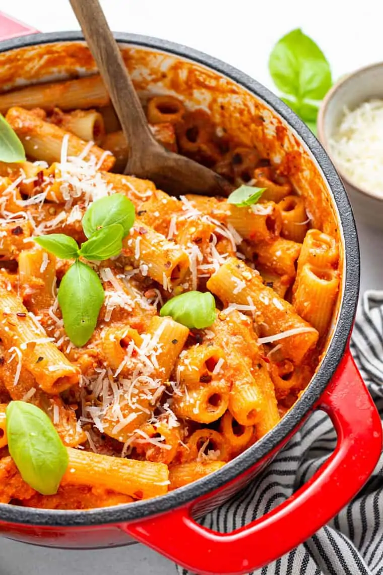 dutch oven with vegan vodka rigatoni pasta with fresh basil and grated parmesan cheese