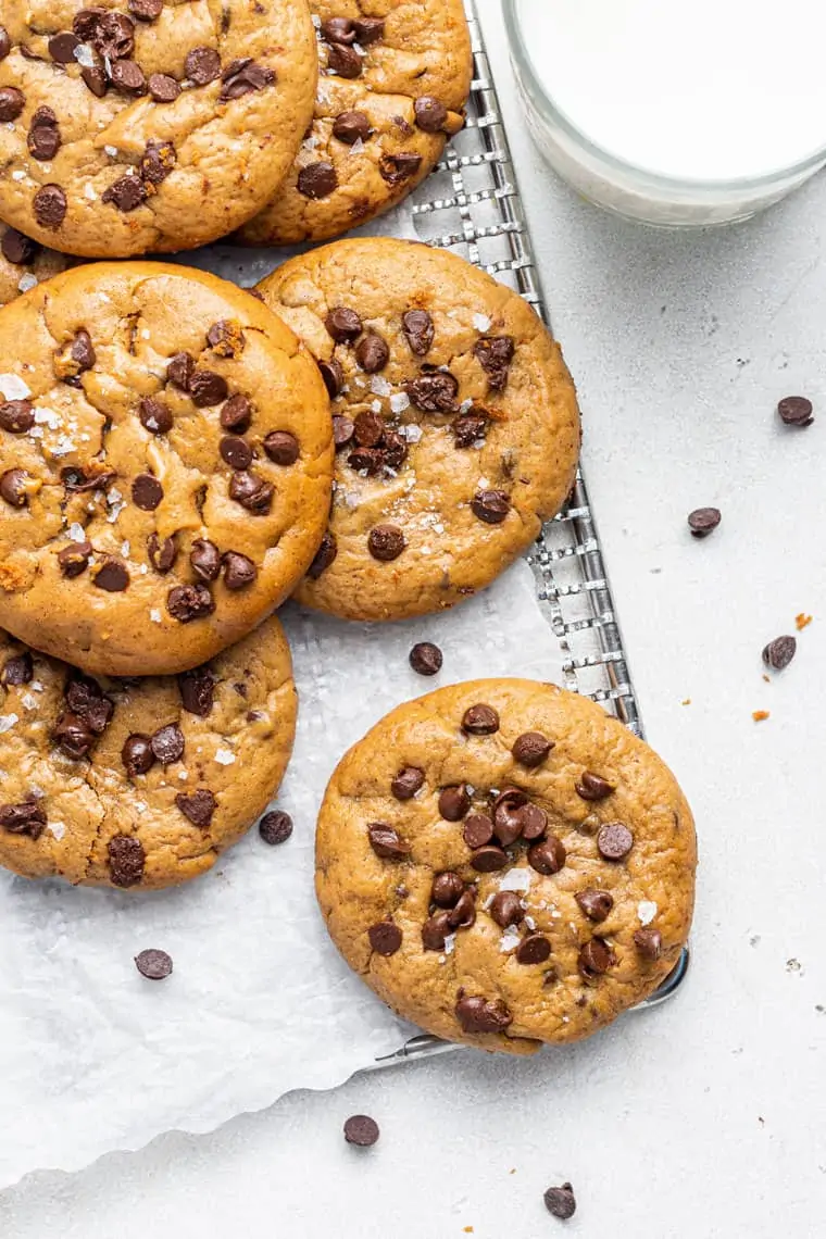 wire rack with almond butter chocolate chip cookies and parchment paper