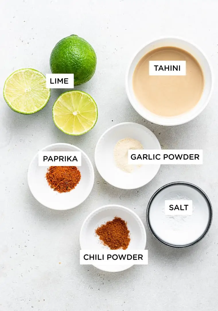 bowls of ingredients to make tahini sauce with lime and chili