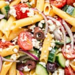 close up on pasta salad with vegetables and olives