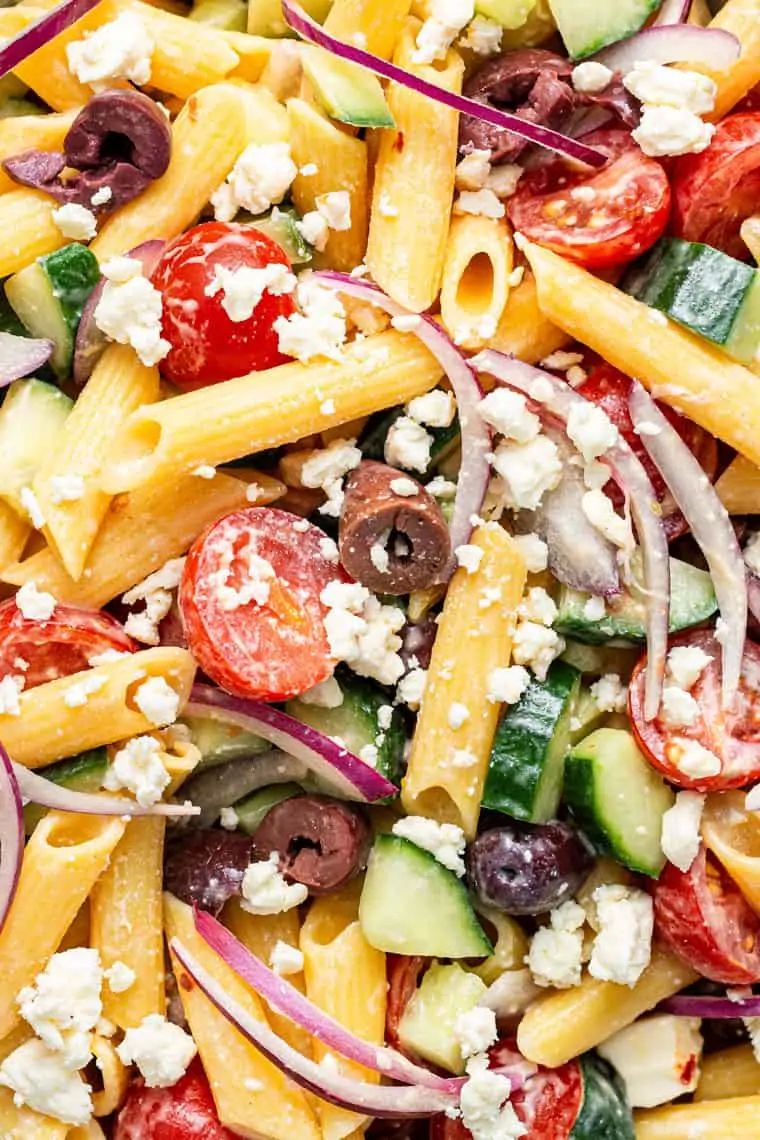 close up on pasta salad with vegetables and olives