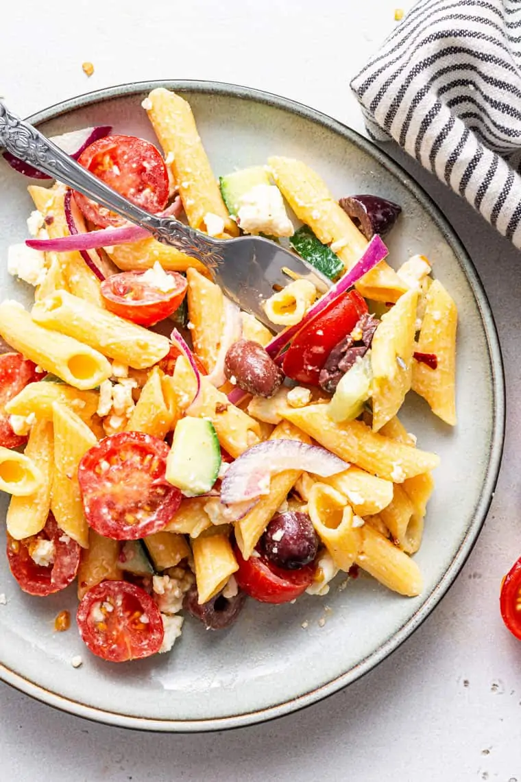 plate of pasta salad with summer vegetables and cheese