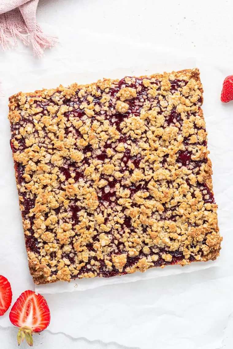 square of strawberry oat bars before slicing