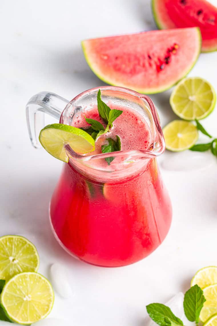 pitcher of watermelon margarita with fresh lime and fresh mint