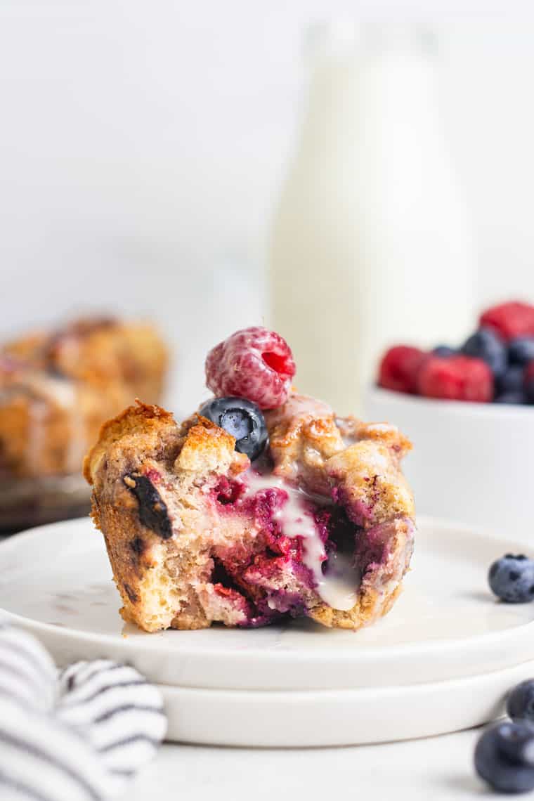 berry french toast muffin that's cut in half on two plates