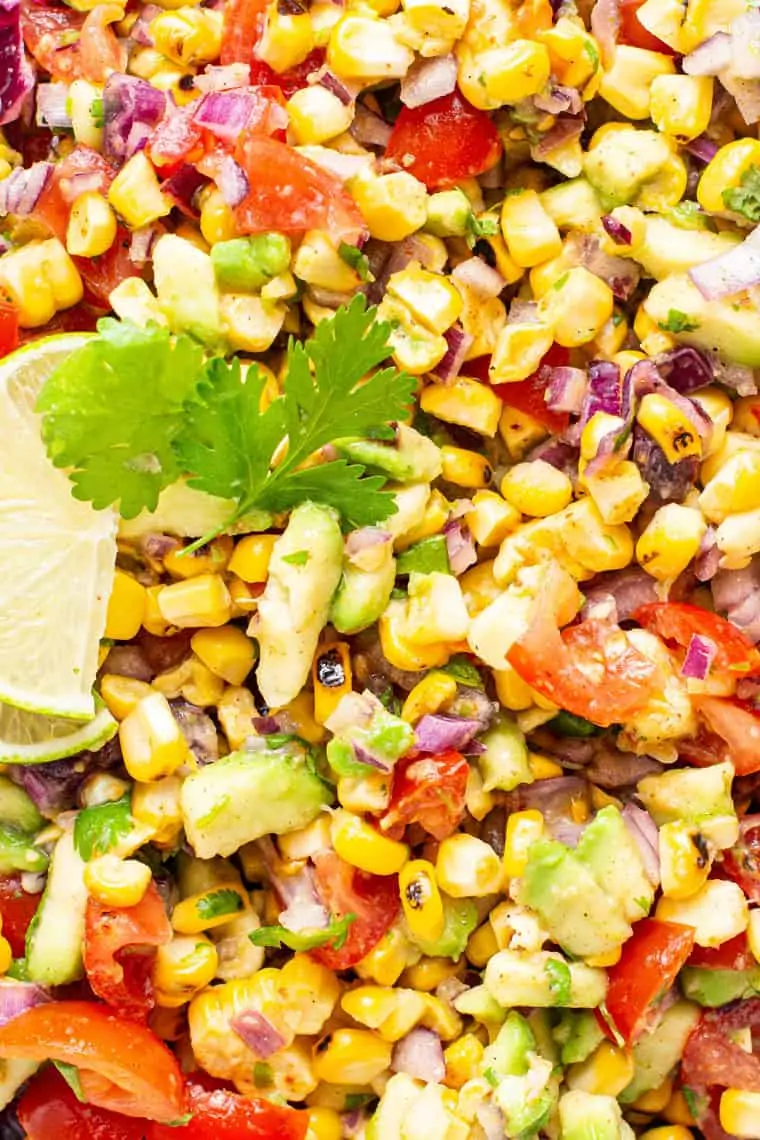 close up on corn, avocado and tomato salad