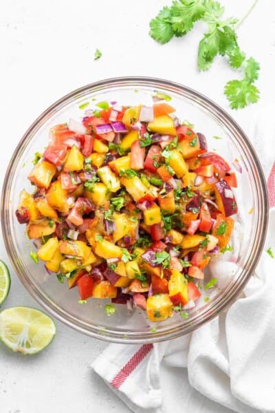 glass bowl of diced peach salsa