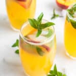 three peach mojitos with mint