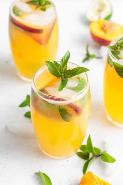 three peach mojitos with mint