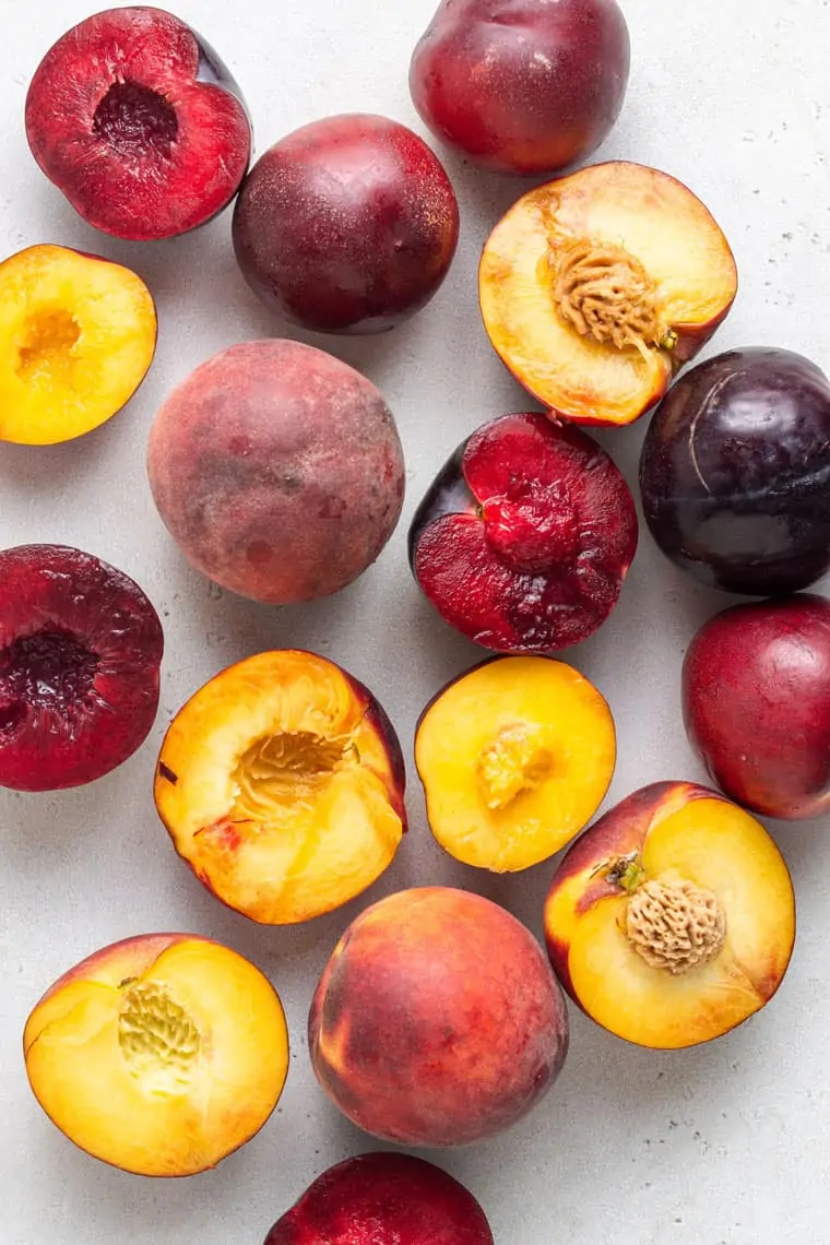 overhead of halved peaches, plums and nectarines