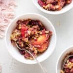 small bowl of plum and peach cumble with quinoa