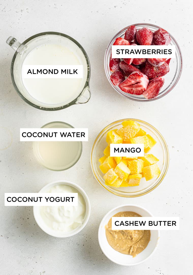 ingredients for strawberry mango smoothies labelled on a white background