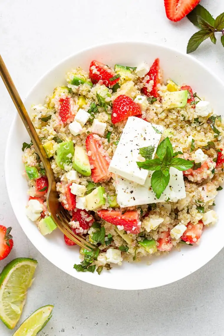 bowl of strawberry, avocado and quinoa salad with feta cheese and lime juice