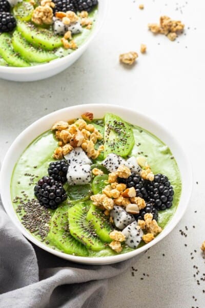 green smoothie bowl with chia seeds, kiwi and berries