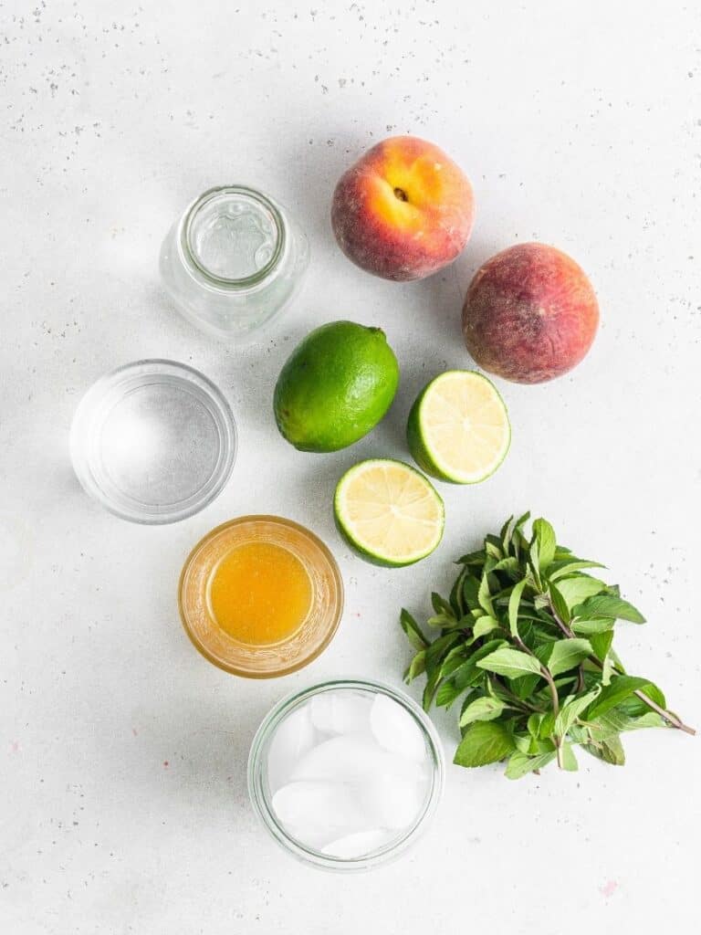 This peach mojito recipe is made with peach purée, white rum, lime, and fresh mint, sweetened with honey for a light, fizzy summer cocktail. Peach mojito ingredients.