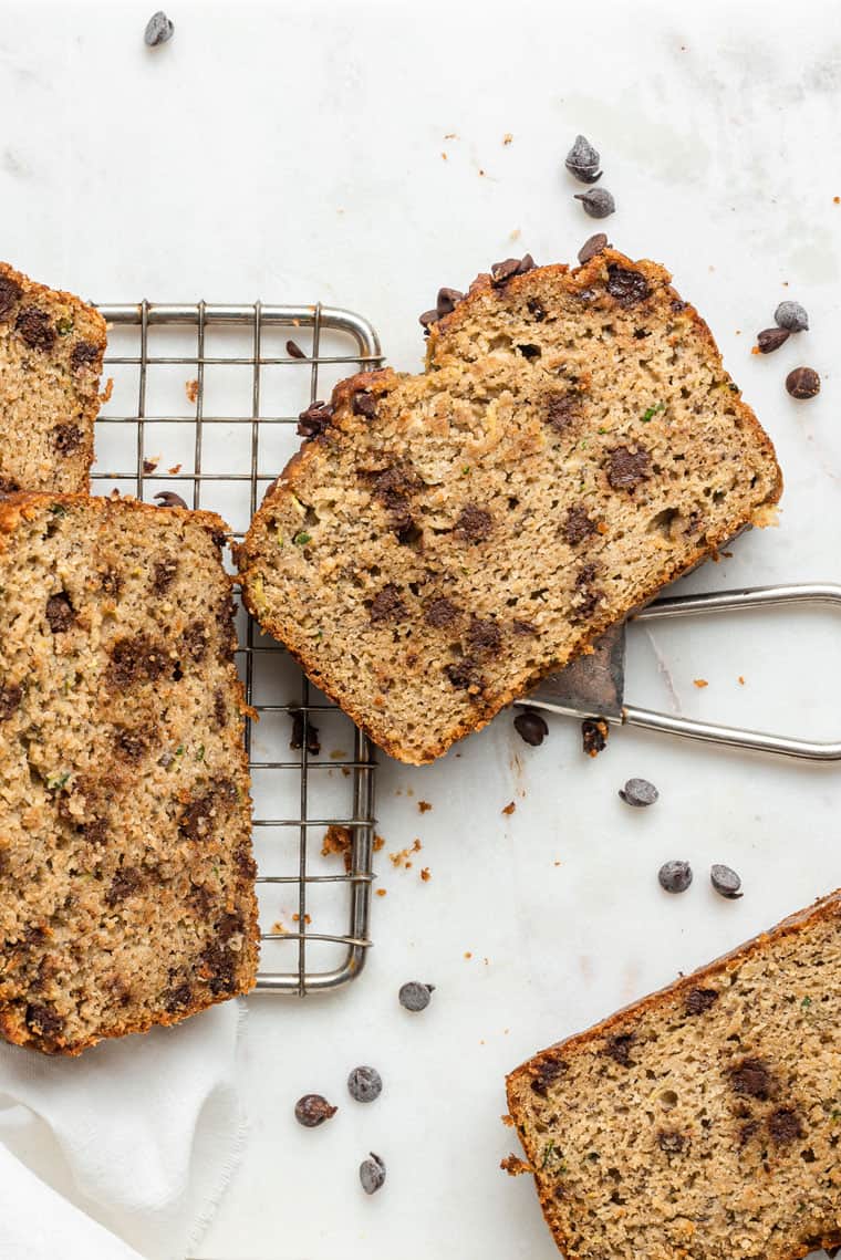 slices of chocolate chip zucchini bread on a wire rack