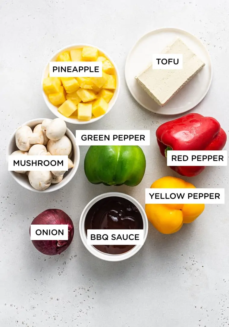 ingredients for kebabs with pineapple, tofu, red pepper, mushrooms and bbq sauce