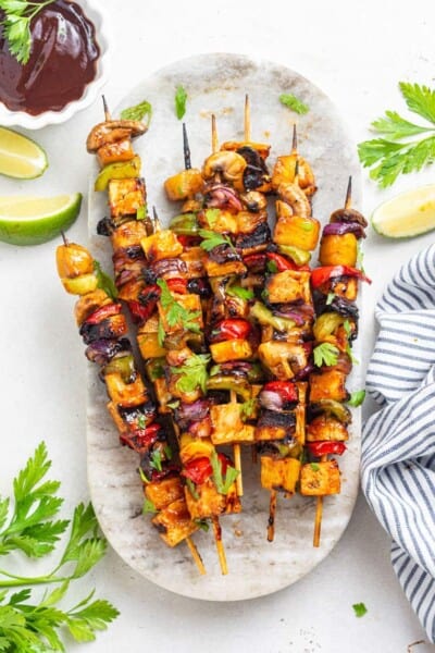 platter of kebabs with bbq sauce, tofu and pinepple