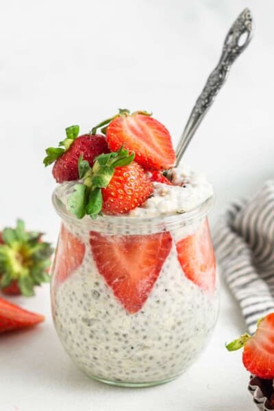 glass jar of overnight oats with strawberries, coconut milk and chia seeds