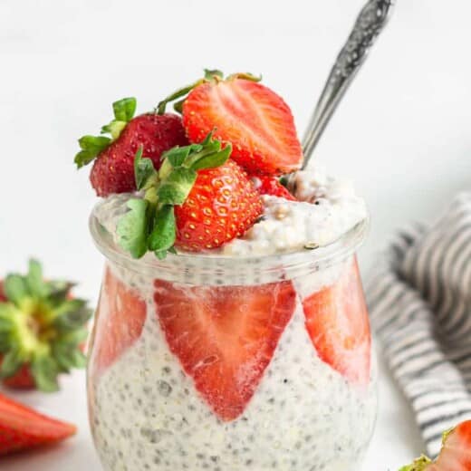 glass jar of overnight oats with strawberries, coconut milk and chia seeds