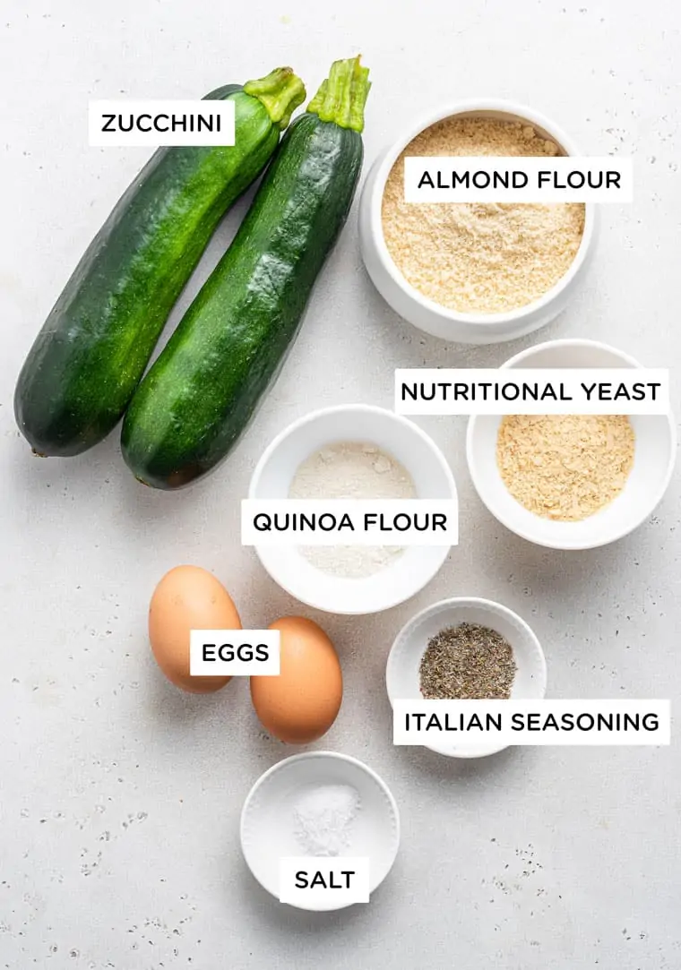 ingredients for pizza crust with zucchini, quinoa flour, almond flour, nutritional yeast and eggs