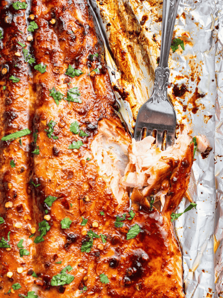 A fork taking a bite of salmon out