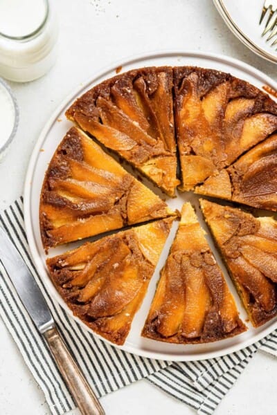 sliced upside down apple cake on a serving platter