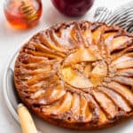 whole apple upside-down cake on a platter