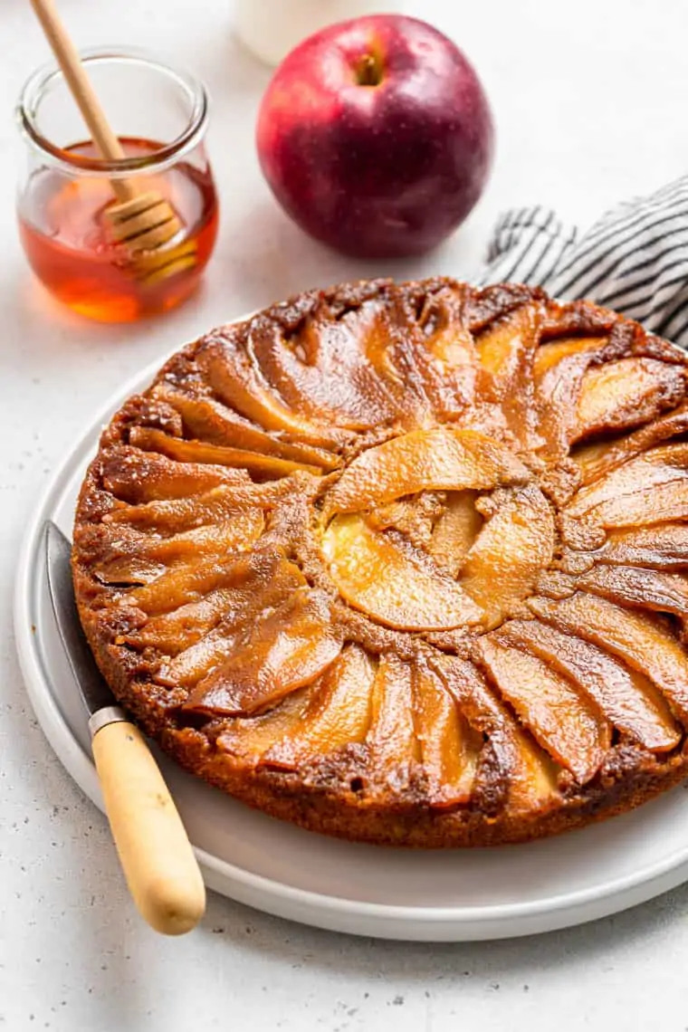 whole apple upside-down cake on a platter