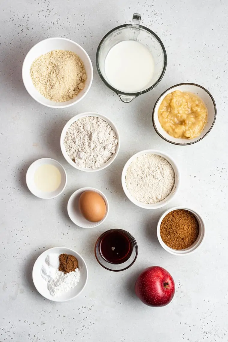 ingredients for muffins with apples, sugar, eggs, vanilla and flour