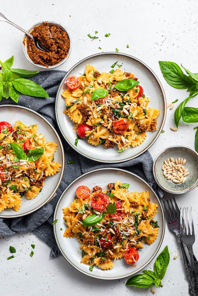 three plates of sun dried tomato pesto pasta