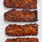 close up of four strips of cooked tempeh bacon