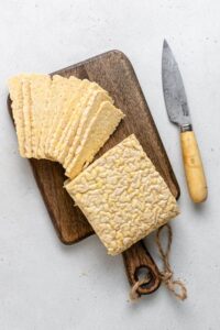overhead of sliced tempeh on a wood cutting board
