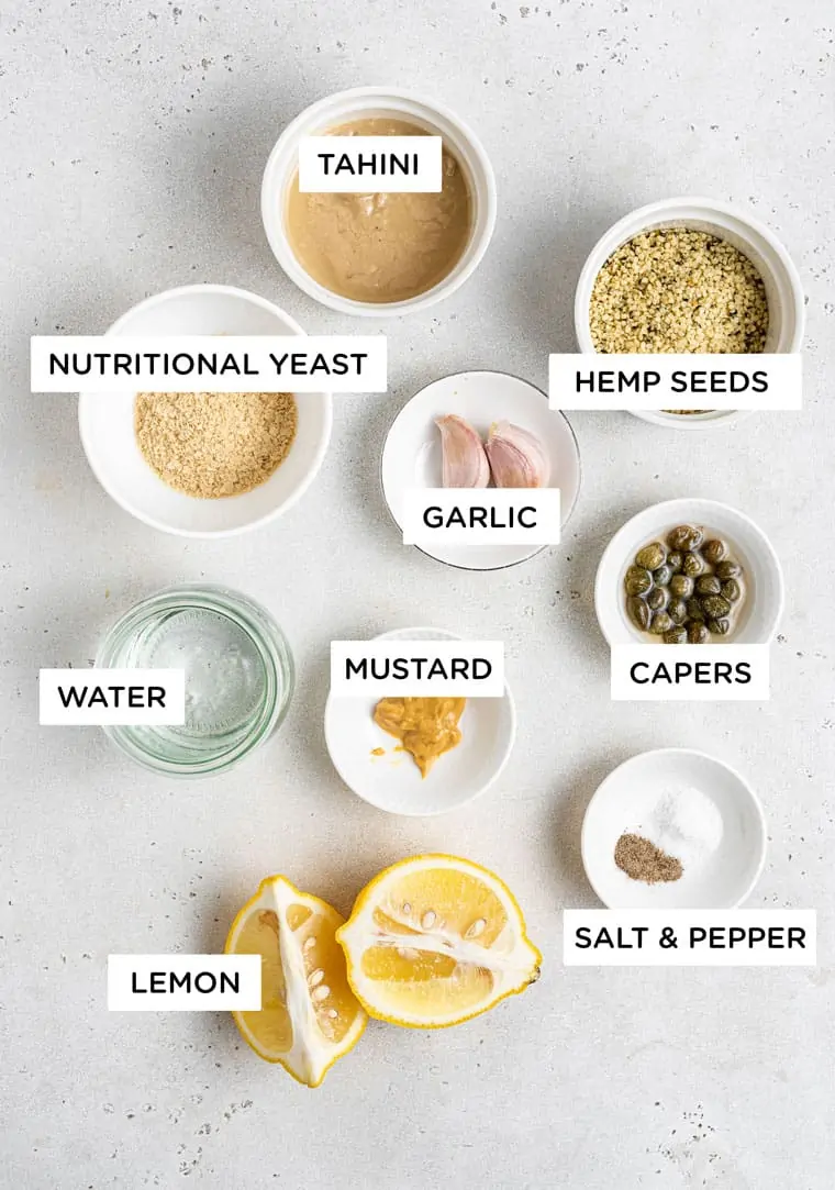 Ingredients for vegan caesar salad dressingwith nutritional yeast, garlic and tahini