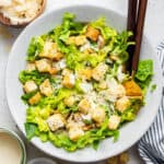 overhead of a bowlof vegan caesar salad with romaine and croutons