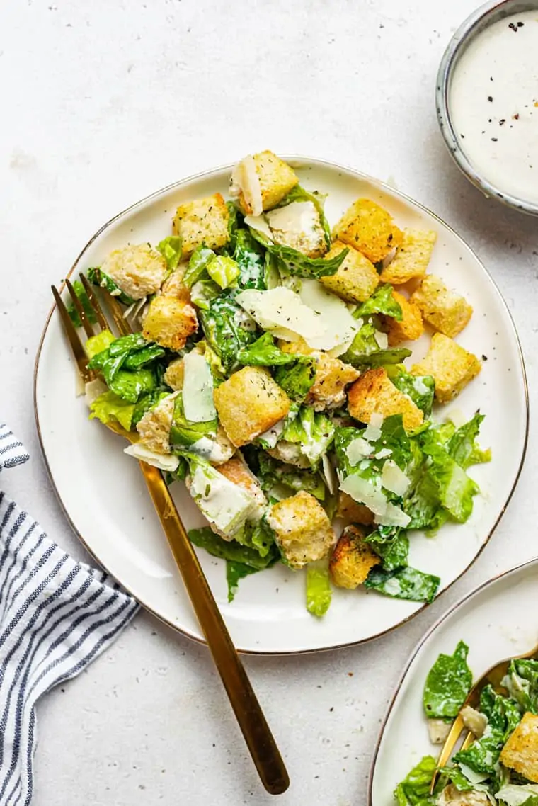 white plate with caesar salad with romaine and dairy free dressing