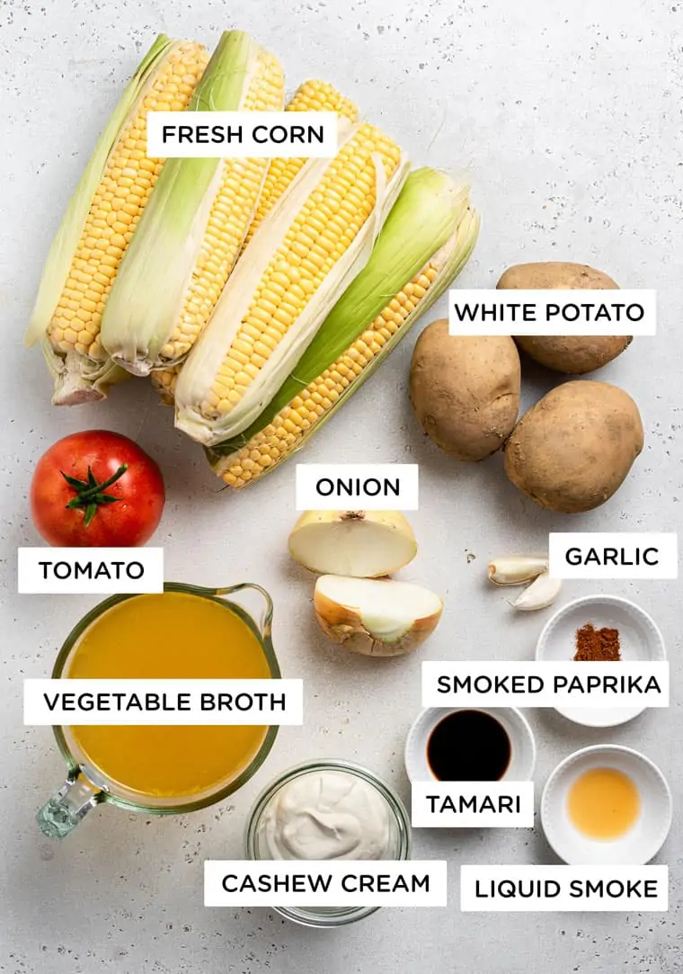 Ingredients for chowder with corn, potatoe, onion, tomato, broth, cashew cream and garlic